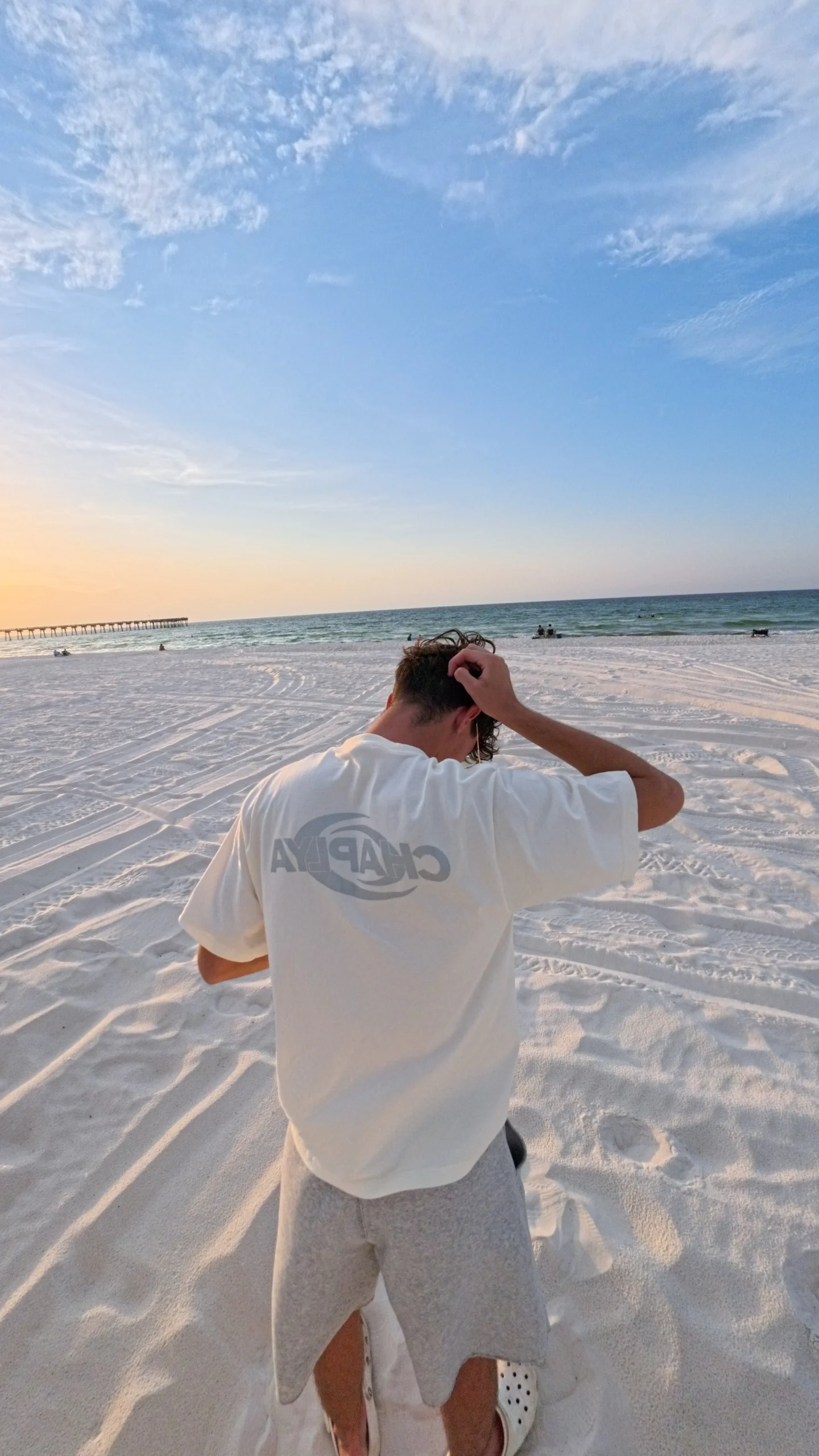 chaplya logo heavyweight tshirt off white beach back Model wearing CHAPLYA Logo Heavyweight T-Shirt in Off White on the beach